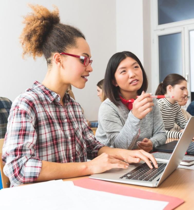 students studying in front of laptop