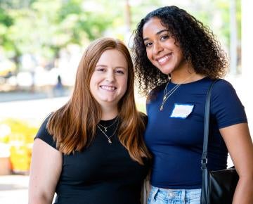 Two students smiling