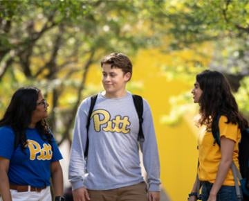 Three Pitt students walk through the Pittsburgh campus.