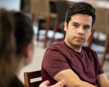 A Pitt student listens intently to a peer.